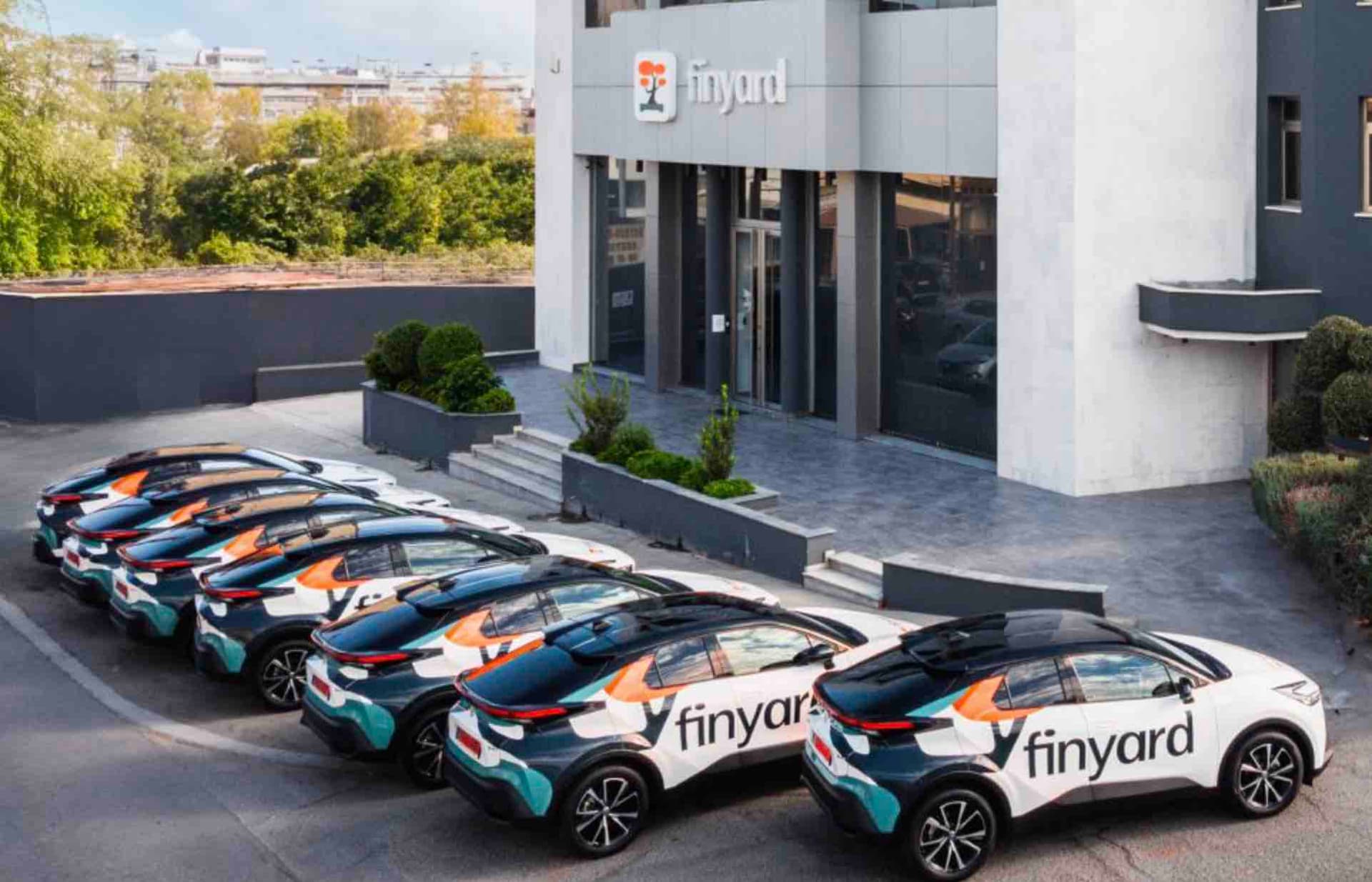 Finyard branded hybrid cars outside office building